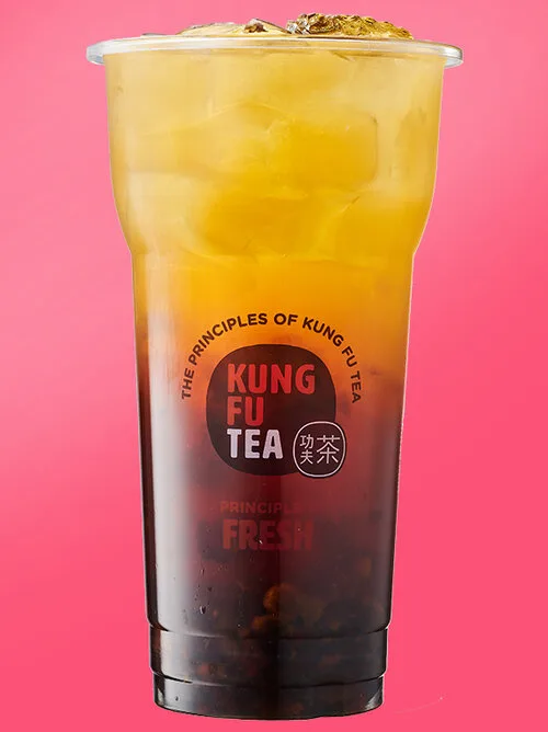 Golden iced fruit tea with fruit cubes in a Kung Fu Tea branded cup.