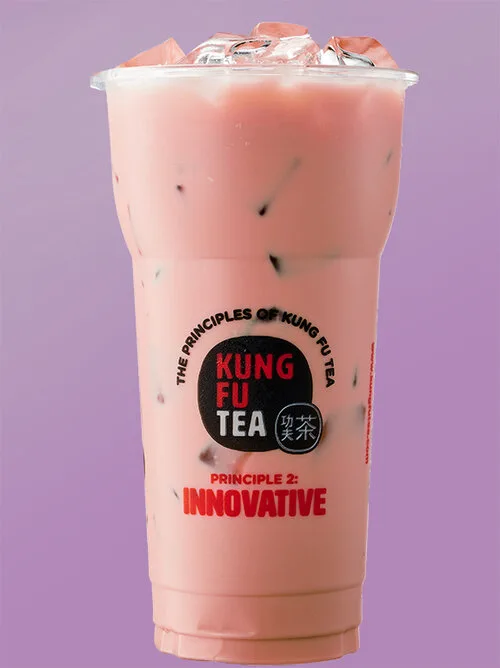 Creamy pastel milk tea served over ice in a Kung Fu Tea branded cup.